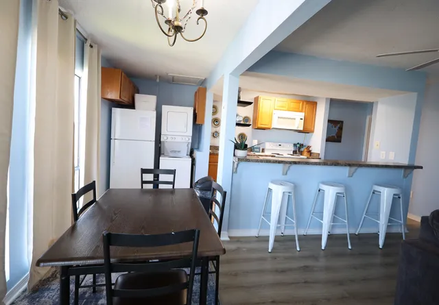 a view of a dining room with furniture and wooden floor