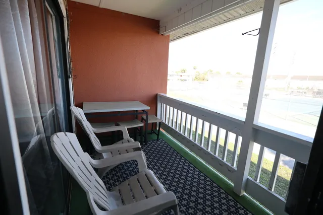 a view of a balcony with furniture