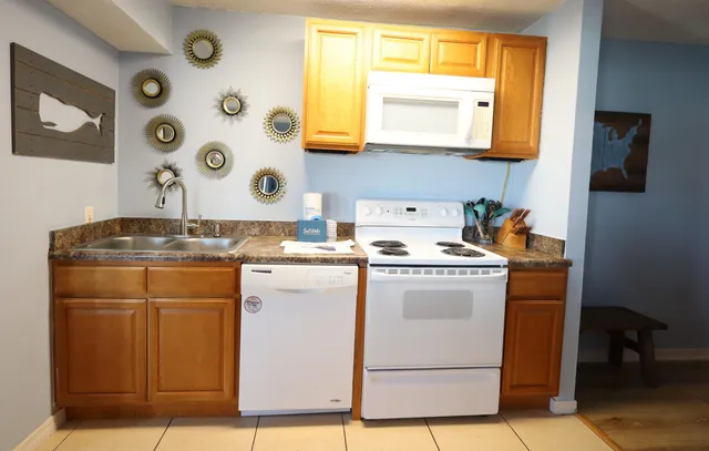 a utility room with cabinets washer and dryer