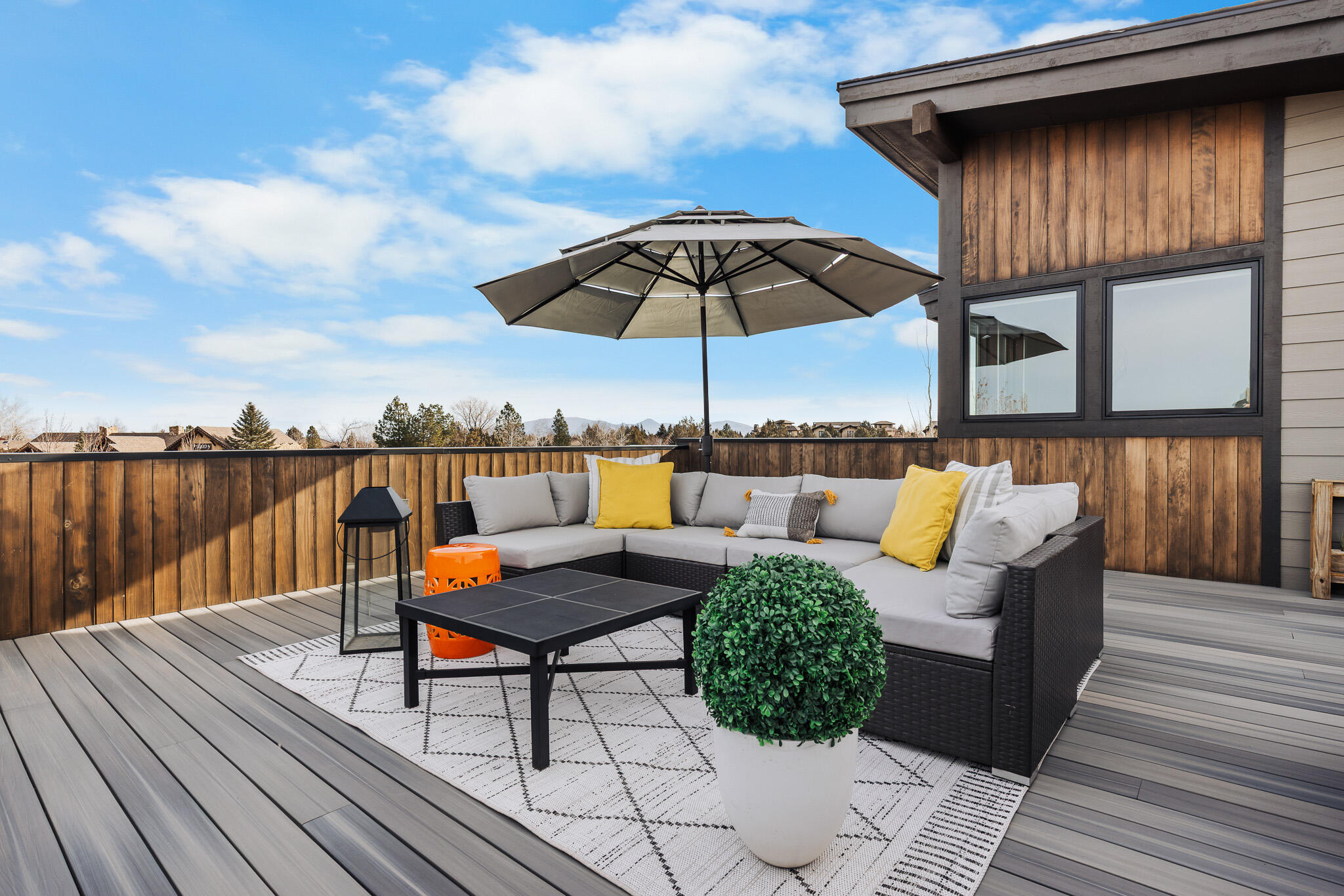 22993 Ghost Tree Lane Bend, OR 97701 - Photo 25 of 35 an outdoor sitting area with furniture and umbrella