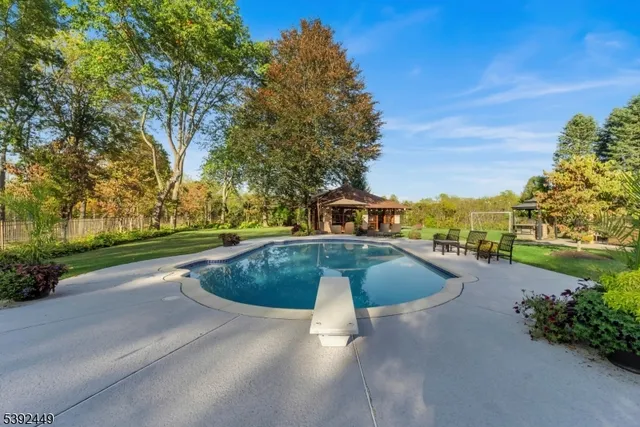a view of a patio with table and chairs under an umbrella