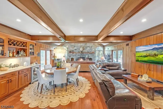 a dining room with furniture a chandelier and wooden floor