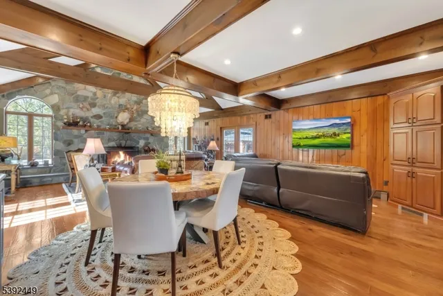 a living room with furniture a fireplace and floor to ceiling windows