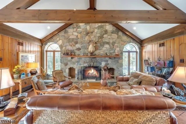 a living room with furniture a fireplace and a table