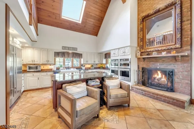 a kitchen with stainless steel appliances granite countertop a sink and a refrigerator