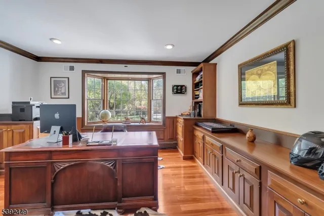 a open kitchen with stainless steel appliances granite countertop a refrigerator and a wooden floor