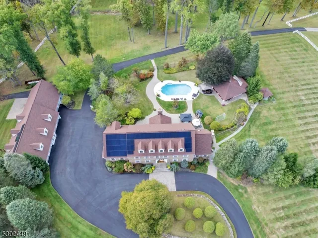 a aerial view of a house with a yard and green space