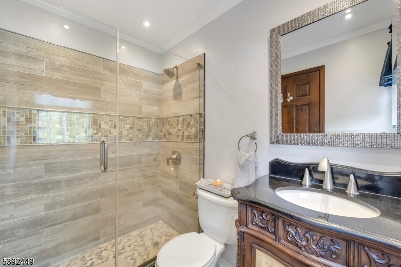 37 Pequest Road Andover, NJ 07821 - Photo 39 of 50 a bathroom with a granite countertop sink mirror vanity and toilet