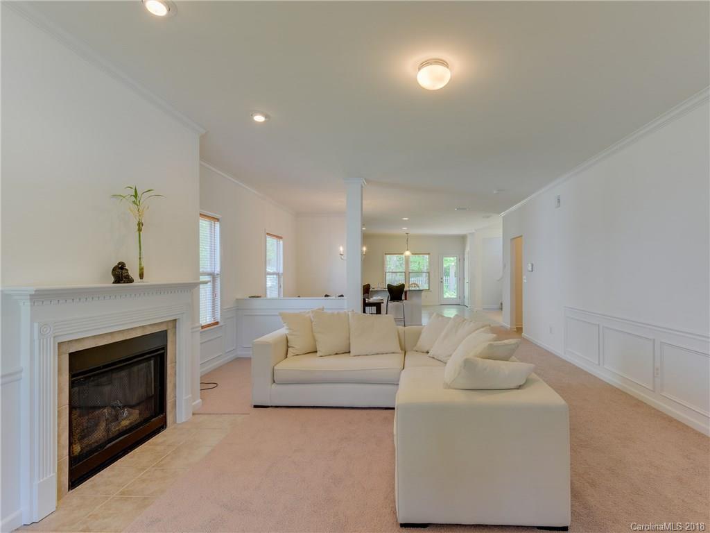 9502 Fernspray Road Charlotte, NC 28215 - Photo 2 of 20 a living room with furniture a fireplace and a chandelier