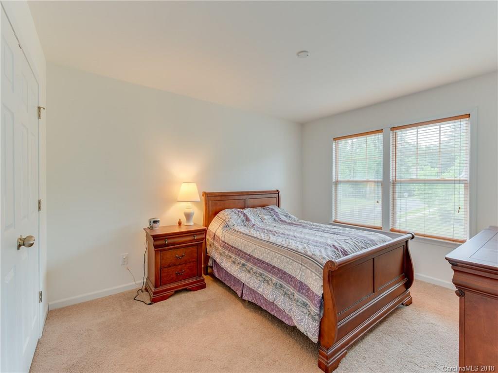 9502 Fernspray Road Charlotte, NC 28215 - Photo 15 of 20 a bed sitting in a bedroom next to a window