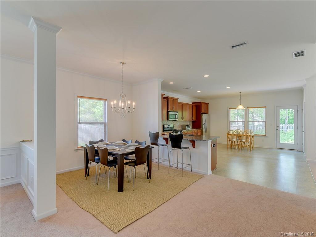9502 Fernspray Road Charlotte, NC 28215 - Photo 3 of 20 a living room with furniture a table and chairs