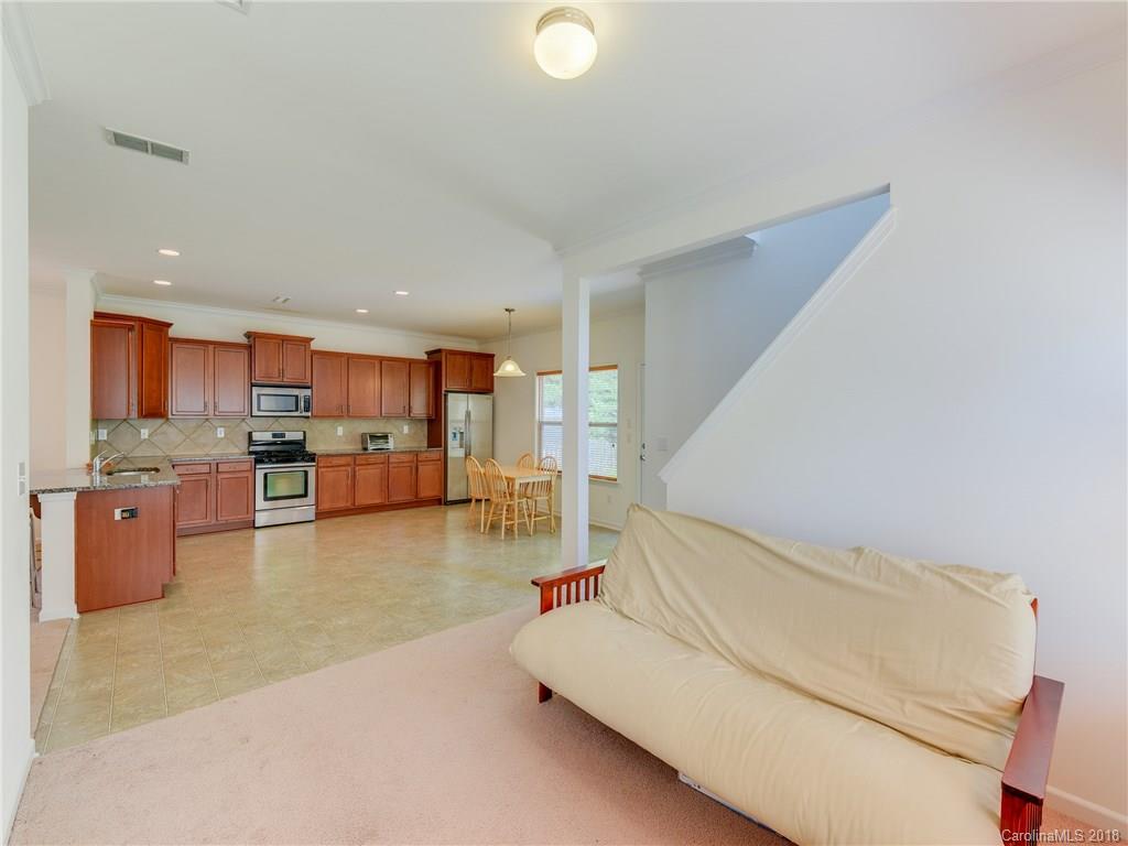 9502 Fernspray Road Charlotte, NC 28215 - Photo 7 of 20 a living room with furniture and kitchen view