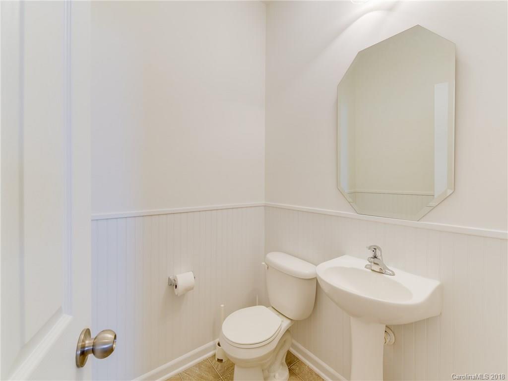 9502 Fernspray Road Charlotte, NC 28215 - Photo 8 of 20 a bathroom with a sink a toilet and a mirror