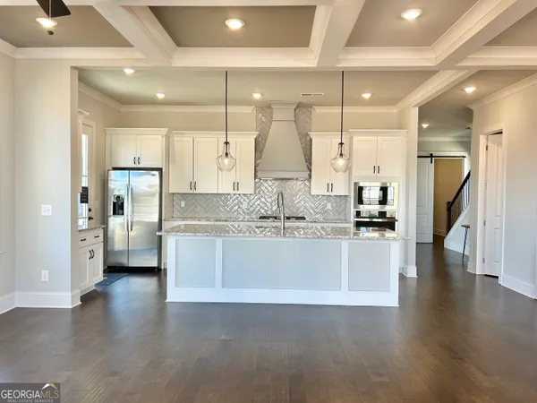 an empty room with windows and fireplace