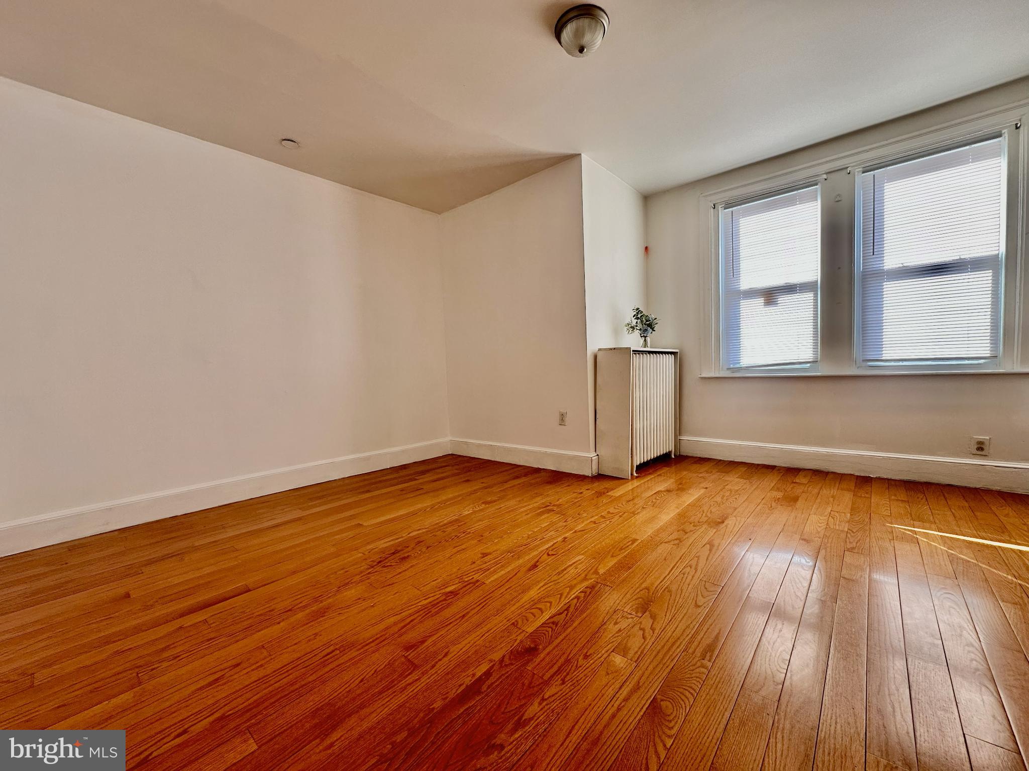 329 Sanford Road Upper Darby, PA 19082 - Photo 12 of 19 an empty room with wooden floor and windows