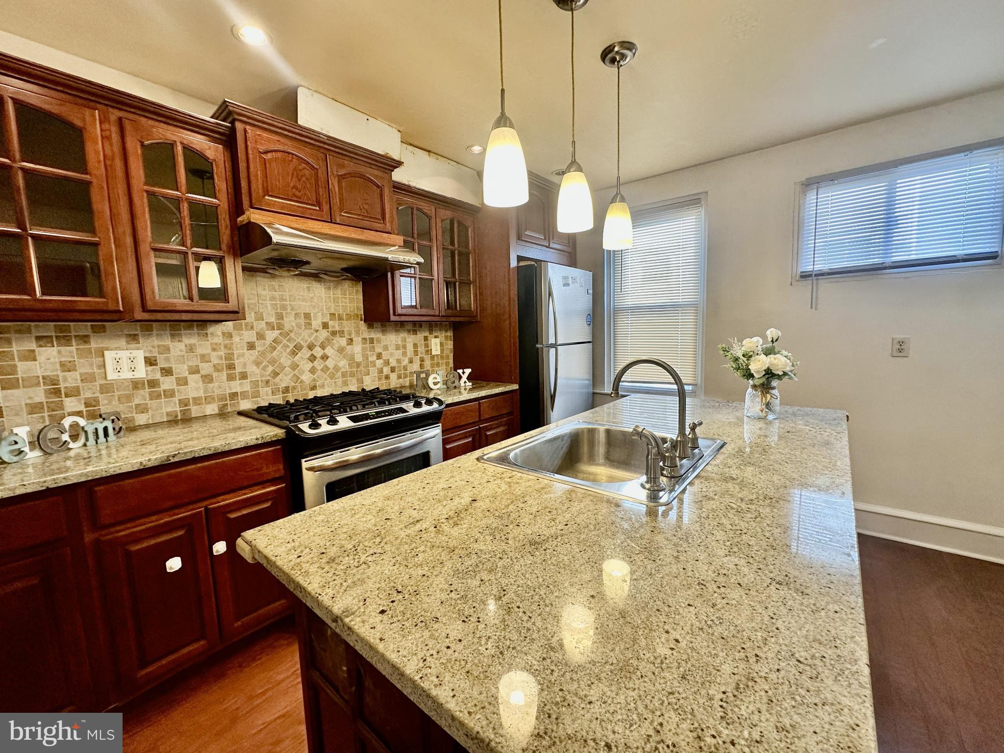 329 Sanford Road Upper Darby, PA 19082 - Photo 9 of 19 a kitchen with stainless steel appliances granite countertop a sink a stove and a wooden cabinets