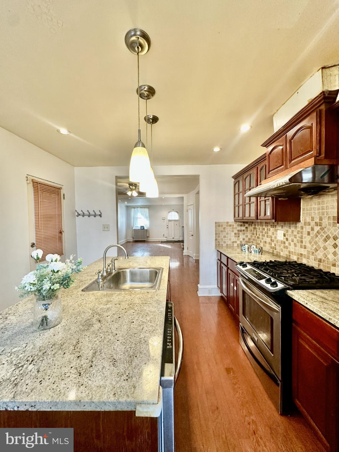 329 Sanford Road Upper Darby, PA 19082 - Photo 10 of 19 a kitchen with kitchen island granite countertop a stove and a sink