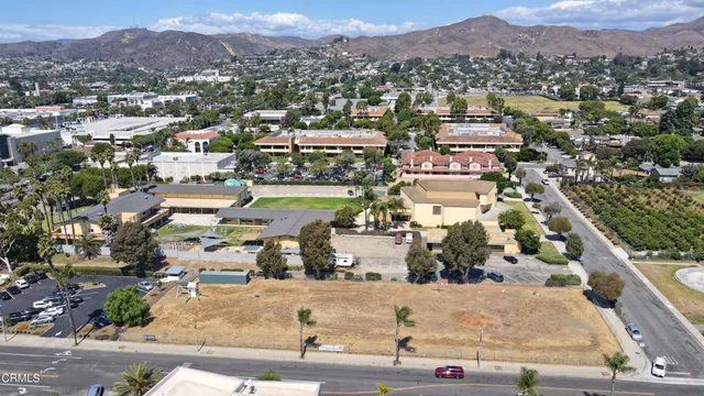 a view of a dry yard with trees