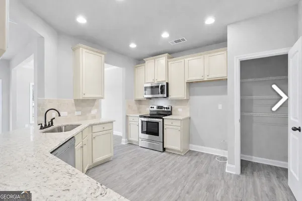 a kitchen with stainless steel appliances granite countertop a sink and cabinets