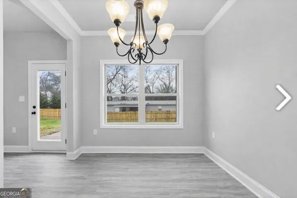 a view of an entryway with wooden floor