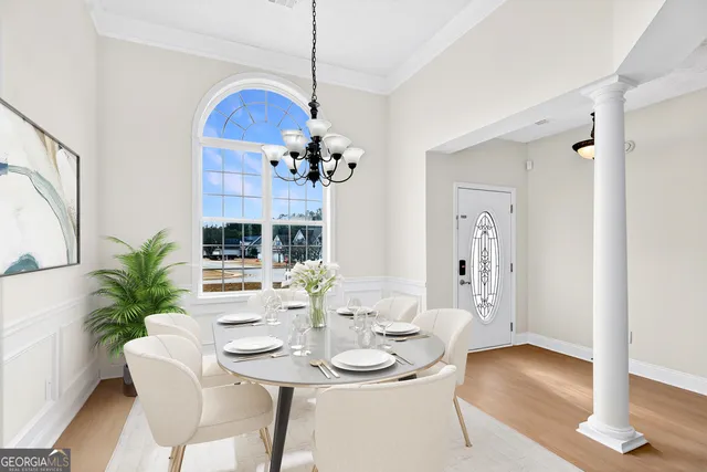 a view of a dining room with furniture wooden floor and chandelier