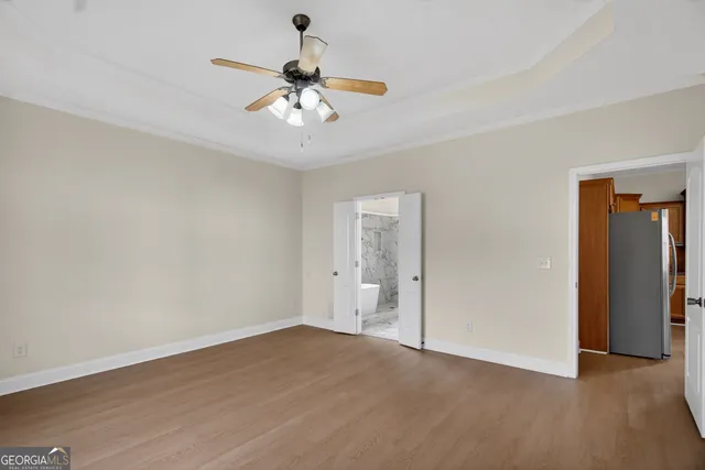 a view of an empty room with wooden floor