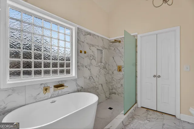 a bathroom with a bathtub and a shower