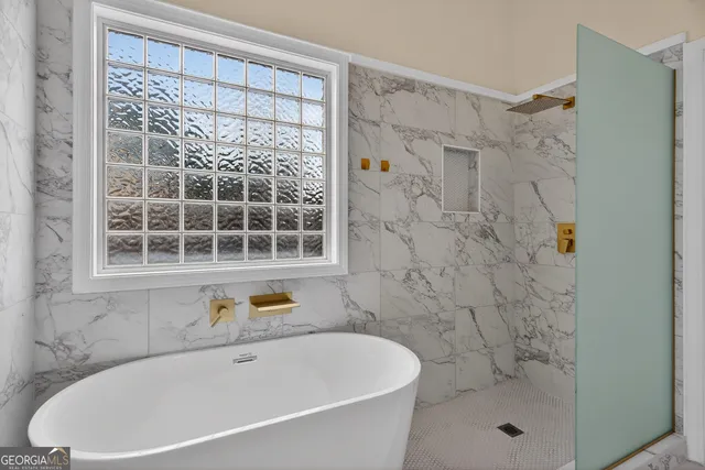 a bathroom with a bathtub and a shower