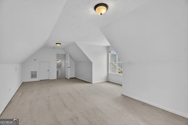 an empty room with a projector and white walls