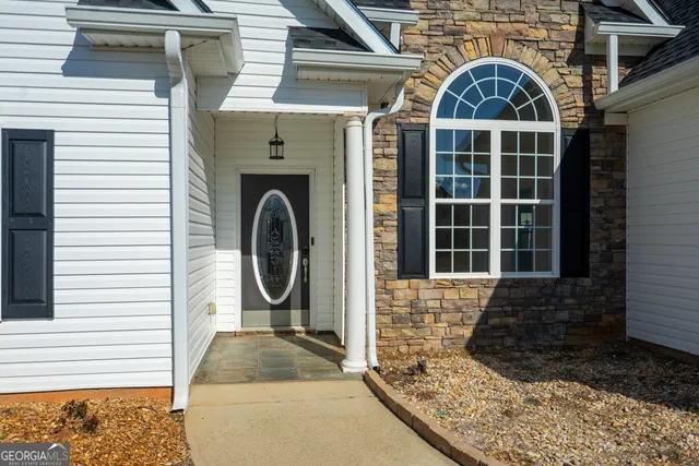a front view of a house with garden