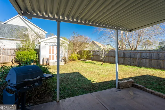 a view of backyard with swimming pool