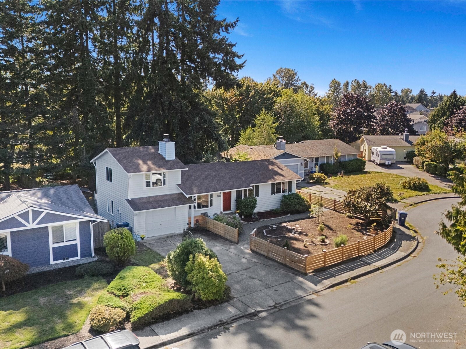an aerial view of a house with a garden and trees