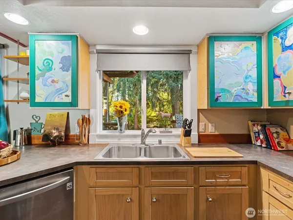 a kitchen with sink and large window