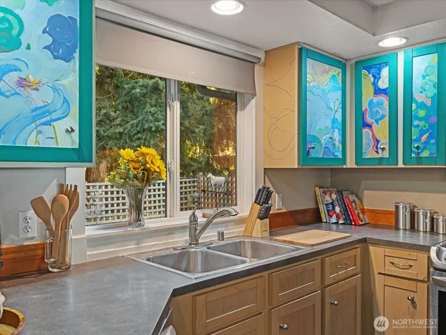 a kitchen with a sink and a large window