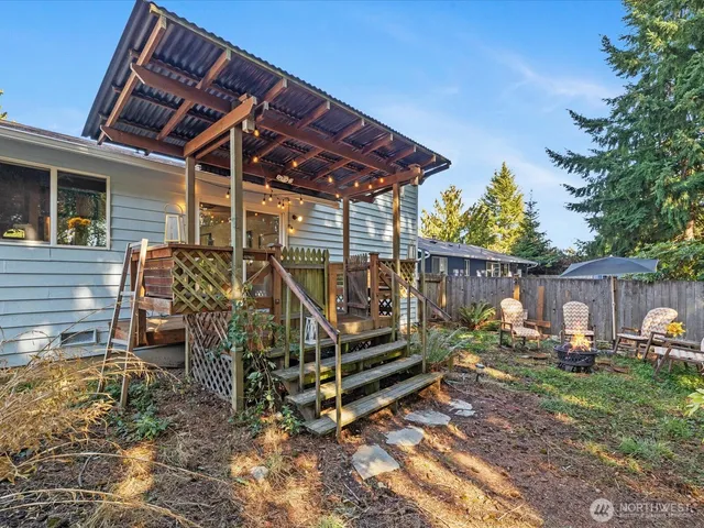 a view of a backyard with sitting area