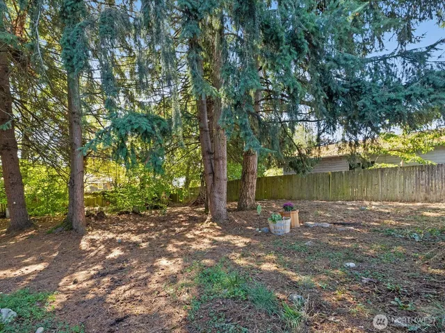 a backyard of a house with lots of green space and fountain