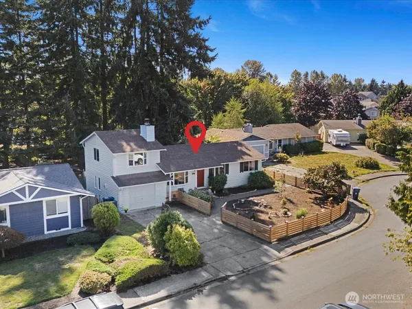 an aerial view of a house with a yard swimming pool and outdoor seating