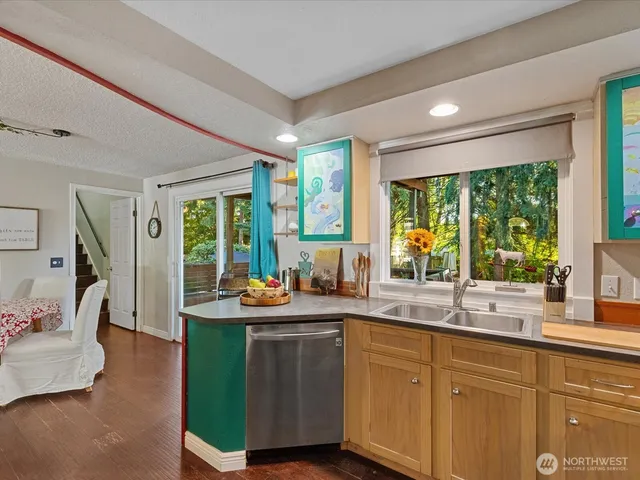 a kitchen with sink cabinets and wooden floor
