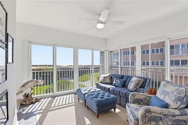 a dining room with wooden floor a chandelier a wooden table and chairs