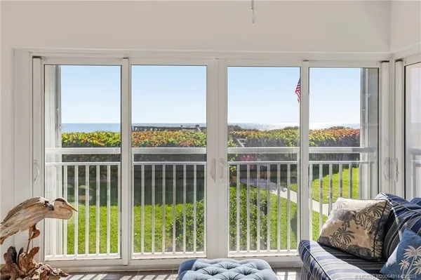 a kitchen with stainless steel appliances granite countertop white cabinets and window