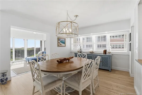 a bedroom with a bed a large window and book shelf