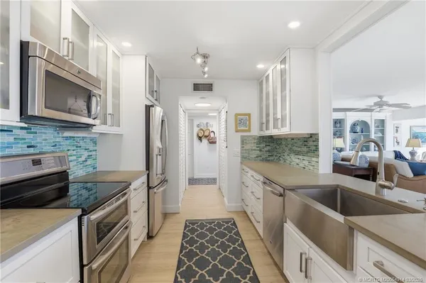 a bathroom with a double vanity sink mirror and shower