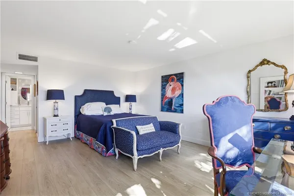 a view of backyard with swimming pool and lawn chairs under an umbrella