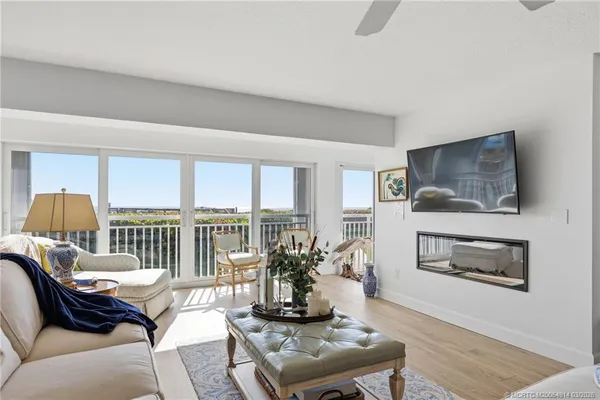 a bedroom with furniture and a large window