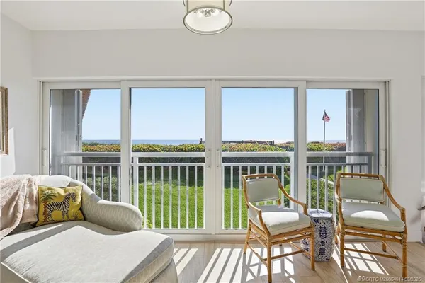 a living room filled with furniture and a large window