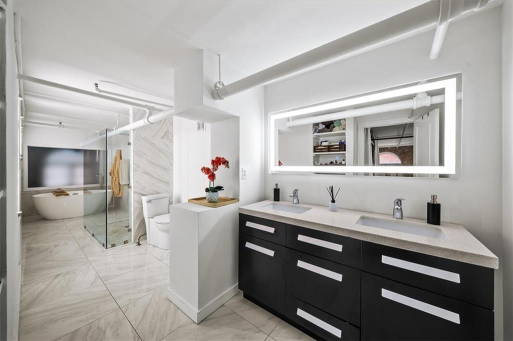 330 Peters Street Southwest, Unit 105 Atlanta, GA 30313 - Photo 16 of 27 a kitchen with a sink appliances and cabinets