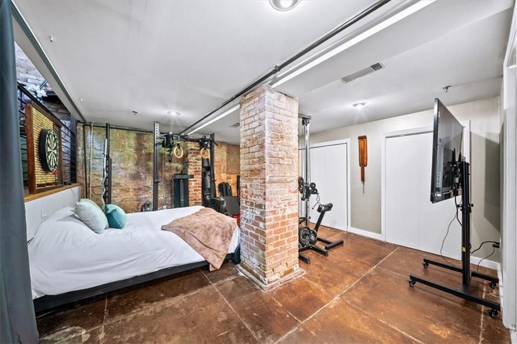 330 Peters Street Southwest, Unit 105 Atlanta, GA 30313 - Photo 18 of 27 a bedroom with furniture and a flat screen tv