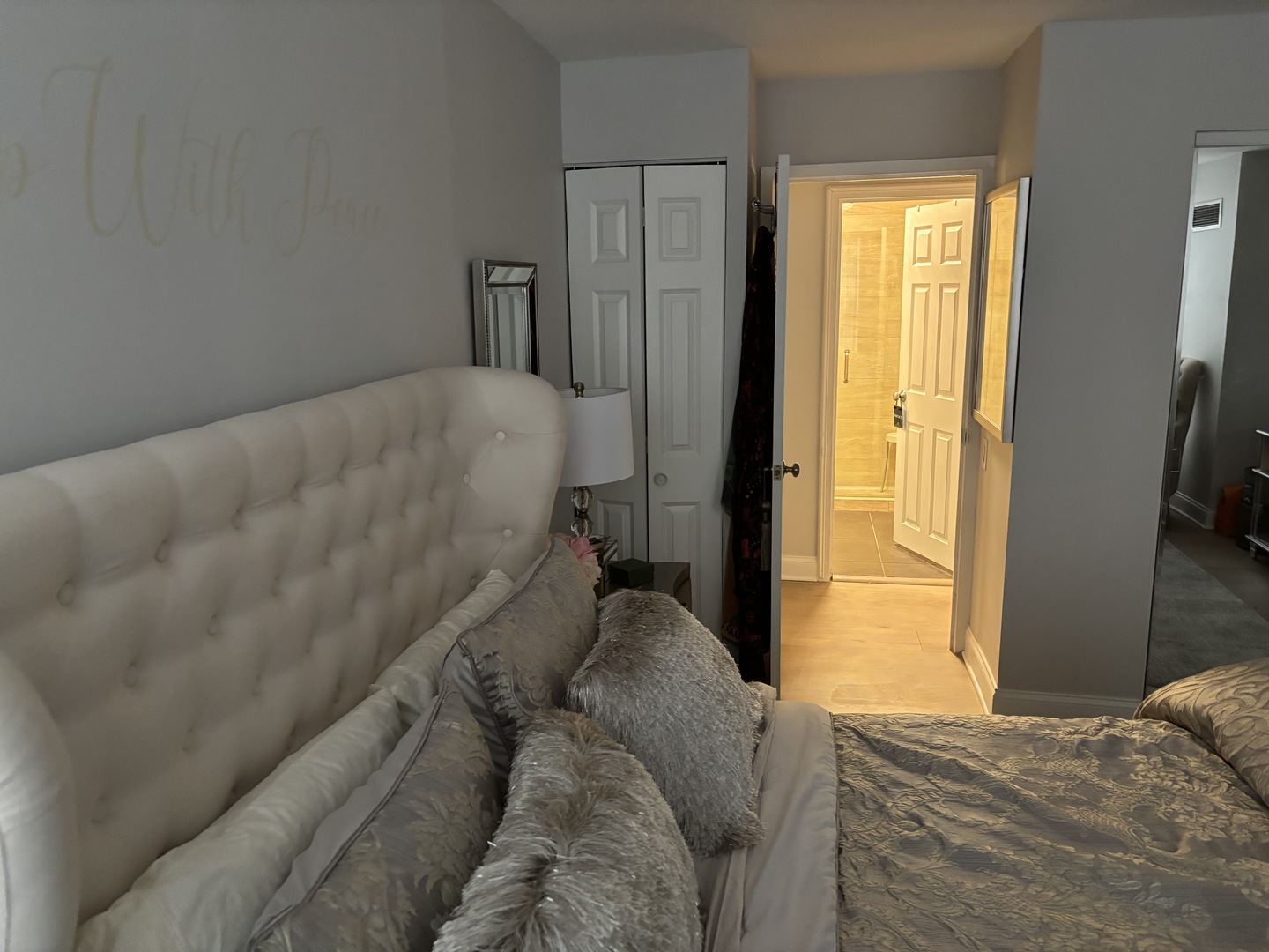 110 East Delaware Place, Unit 2003 Chicago, IL 60611 - Photo 9 of 13 a bed sitting in a bedroom next to a window and a flat tv screen