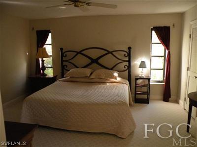 1287 Sand Castle Road Sanibel, FL 33957 - Photo 4 of 9 a bedroom with a bed and a painting on the wall