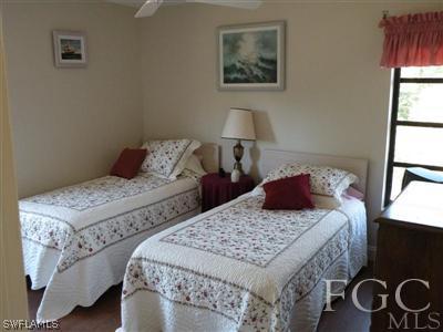 1287 Sand Castle Road Sanibel, FL 33957 - Photo 5 of 9 a bedroom with a bed and a window